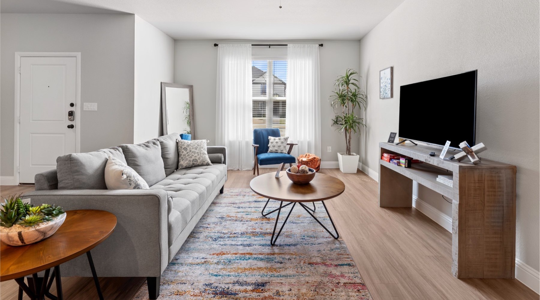 a living room with a couch, tv and a coffee table