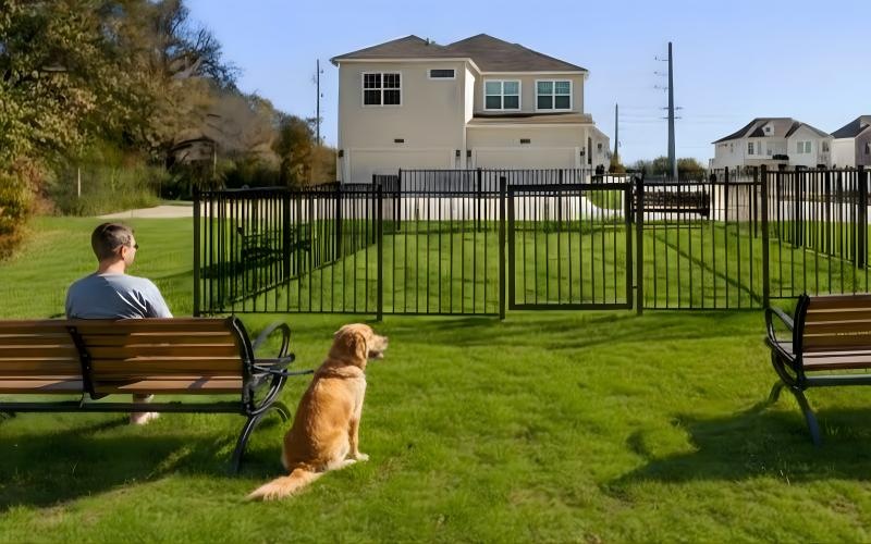 a person and a dog sitting on a bench in a park