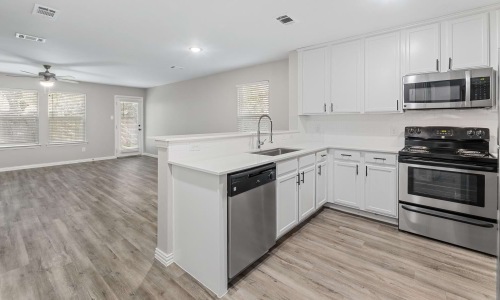 a kitchen with white cabinets